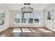 Sunny dining area features large windows, modern lighting and beautiful hardwood flooring at 1861 Dyer Cir, Atlanta, GA 30341