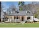Charming home featuring a covered front porch, two dormers, and manicured lawn at 1861 Dyer Cir, Atlanta, GA 30341