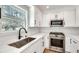 Bright kitchen with stainless steel appliances, white cabinets, subway tile backsplash, and quartz countertops at 1861 Dyer Cir, Atlanta, GA 30341