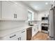 Well-lit kitchen featuring white cabinets, quartz countertops, subway tile backsplash, and stainless steel appliances at 1861 Dyer Cir, Atlanta, GA 30341