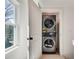 A laundry closet with a stacked washer and dryer combination and a window at 1861 Dyer Cir, Atlanta, GA 30341