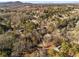 Scenic aerial view of a neighborhood surrounded by lush trees and distant mountain views at 4519 Glenforest Ne Dr, Roswell, GA 30075