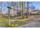 Large backyard with mature trees, featuring a swing set, a multi-level deck and wooded views at 4519 Glenforest Ne Dr, Roswell, GA 30075