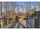 Backyard view from the deck with a railing, showing the wooded surroundings and providing a serene outdoor space at 4519 Glenforest Ne Dr, Roswell, GA 30075