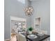Elegant dining room with vaulted ceiling, modern chandelier, and views of living room at 4519 Glenforest Ne Dr, Roswell, GA 30075