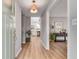 Bright entryway featuring hardwood floors, a modern light fixture and leading to the kitchen at 4519 Glenforest Ne Dr, Roswell, GA 30075