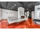 Unique game room with modern decor, featuring red floors, built-in seating, and a ping pong table that doubles as a bar at 4519 Glenforest Ne Dr, Roswell, GA 30075