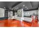 Spacious game room features a unique ping pong table/bar with built in seating, modern lighting, and polished red floors at 4519 Glenforest Ne Dr, Roswell, GA 30075