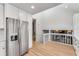 Spacious kitchen featuring stainless steel refrigerator and open layout with white cabinets at 4519 Glenforest Ne Dr, Roswell, GA 30075