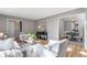 Bright living room with hardwood floors and gray walls, transitioning into dining area with a chandelier-lit table at 4519 Glenforest Ne Dr, Roswell, GA 30075