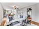 Comfortable living room features hardwood floors, modern decor, and seamless transition to the kitchen and dining area at 4519 Glenforest Ne Dr, Roswell, GA 30075