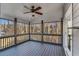 Relaxing screened porch with wood floors and ceiling fan, perfect for enjoying the outdoors in comfort at 4519 Glenforest Ne Dr, Roswell, GA 30075