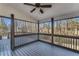 Screened porch with a ceiling fan and wood decking, offering a peaceful view of the surrounding trees at 4519 Glenforest Ne Dr, Roswell, GA 30075