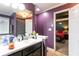 Primary bathroom with dual sinks, vanity, and view to the primary bedroom at 531 Lindsey Way, Social Circle, GA 30025