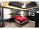 Stylish bedroom with dark accent walls and ample natural light from two windows at 531 Lindsey Way, Social Circle, GA 30025