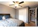 Cozy bedroom features a ceiling fan, closet, and comfortable bed with blue pillows and a grey comforter at 531 Lindsey Way, Social Circle, GA 30025