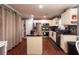 Modern kitchen with stainless steel appliances, white cabinets, and granite countertops at 531 Lindsey Way, Social Circle, GA 30025