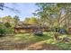 Lush backyard featuring mature trees, a trampoline, and wooded landscape at 615 Upland Nw Trl, Conyers, GA 30012