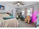 A cozy bedroom featuring a bed, desk and chair with decor showcasing a colorful snowman art piece at 615 Upland Nw Trl, Conyers, GA 30012