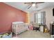 Charming bedroom featuring a crib, desk area, and whimsical decor, perfect for a Bedroom or room at 615 Upland Nw Trl, Conyers, GA 30012