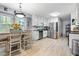 Bright kitchen featuring stainless steel appliances, white cabinetry, and an adjacent dining area at 615 Upland Nw Trl, Conyers, GA 30012