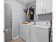 A well-organized laundry room featuring a washer, dryer, and upper cabinets for storage at 615 Upland Nw Trl, Conyers, GA 30012