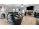 Spacious living room featuring hardwood floors, a stone fireplace, and lots of natural light at 615 Upland Nw Trl, Conyers, GA 30012