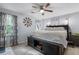 Cozy bedroom featuring neutral tones, a ceiling fan, and ample natural light from the window at 615 Upland Nw Trl, Conyers, GA 30012