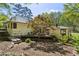 Landscaped back yard featuring mature trees, decks, and well-maintained greenery, which creates a private retreat at 240 W Spalding Dr, Sandy Springs, GA 30328