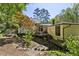 Large back yard with lush landscaping and bridges connecting the decks of the home to the property at 240 W Spalding Dr, Sandy Springs, GA 30328