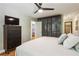 Bedroom featuring hardwood floors, ceiling fan, modern closet and neutral decor at 240 W Spalding Dr, Sandy Springs, GA 30328