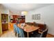 Open concept dining room with hardwood floors, seamless access to the kitchen, and seating for eight at 240 W Spalding Dr, Sandy Springs, GA 30328
