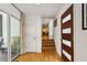 Bright entryway with modern wood door, hardwood floors, and access to a patio through sliding glass doors at 240 W Spalding Dr, Sandy Springs, GA 30328