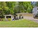 Charming ranch-style home with a two-car garage, beautiful landscaping, and a well-manicured lawn at 240 W Spalding Dr, Sandy Springs, GA 30328