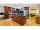 Well-appointed kitchen featuring cherry cabinets, stainless steel appliances, and a center island with seating at 240 W Spalding Dr, Sandy Springs, GA 30328