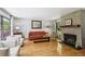 Spacious living room features a stone fireplace, large windows, and an open layout with hardwood floors at 240 W Spalding Dr, Sandy Springs, GA 30328
