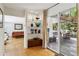 Bright living room with hardwood floors, modern glass shelving and view to the outdoor deck at 240 W Spalding Dr, Sandy Springs, GA 30328