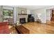 Living room with hardwood floors, large window with natural light and stone fireplace at 240 W Spalding Dr, Sandy Springs, GA 30328