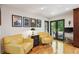 Inviting living room featuring hardwood floors, comfortable yellow armchairs, and bright, natural lighting at 240 W Spalding Dr, Sandy Springs, GA 30328