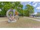 A large metal sculpture in a park setting with mature trees and blue skies at 240 W Spalding Dr, Sandy Springs, GA 30328