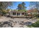 Backyard featuring a wooden deck, concrete patio, and lush greenery, ideal for outdoor living and entertainment at 2992 Westminster Nw Cir, Atlanta, GA 30327