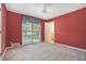 Bedroom with carpet flooring, ceiling fan, and a window looking out to the neighborhood at 2992 Westminster Nw Cir, Atlanta, GA 30327