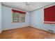 Bedroom featuring hardwood floors, ceiling fan, and a large window providing ample natural light at 2992 Westminster Nw Cir, Atlanta, GA 30327