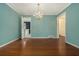 Elegant dining room featuring hardwood floors, blue wall paint, chandelier lighting, and open entryways at 2992 Westminster Nw Cir, Atlanta, GA 30327