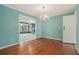 Elegant dining room featuring hardwood floors, blue wall paint, chandelier lighting, and open entryways at 2992 Westminster Nw Cir, Atlanta, GA 30327