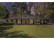 Charming single-story home with a well-manicured lawn, a red front door and a covered front porch at 2992 Westminster Nw Cir, Atlanta, GA 30327