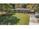 Traditional single-story home with a well-manicured lawn and a covered front porch, complemented by mature trees at 2992 Westminster Nw Cir, Atlanta, GA 30327