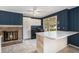 Eat-in kitchen features a brick fireplace, white cabinets, and a breakfast bar for casual dining at 2992 Westminster Nw Cir, Atlanta, GA 30327