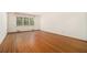 Spacious living room with hardwood floors, large window with view of outdoors, and white wall paint at 2992 Westminster Nw Cir, Atlanta, GA 30327