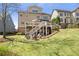 Expansive backyard with a lush lawn, fire pit, and spacious deck perfect for outdoor entertaining at 3225 Suffolk Dr, Cumming, GA 30041